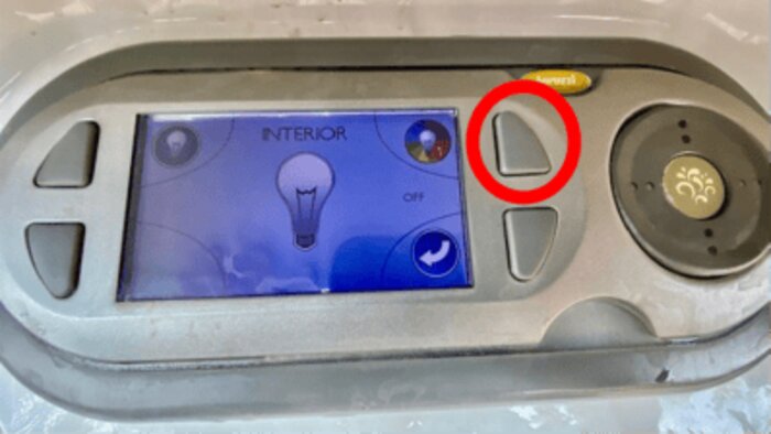 Hot tub control panel with the light control button circled